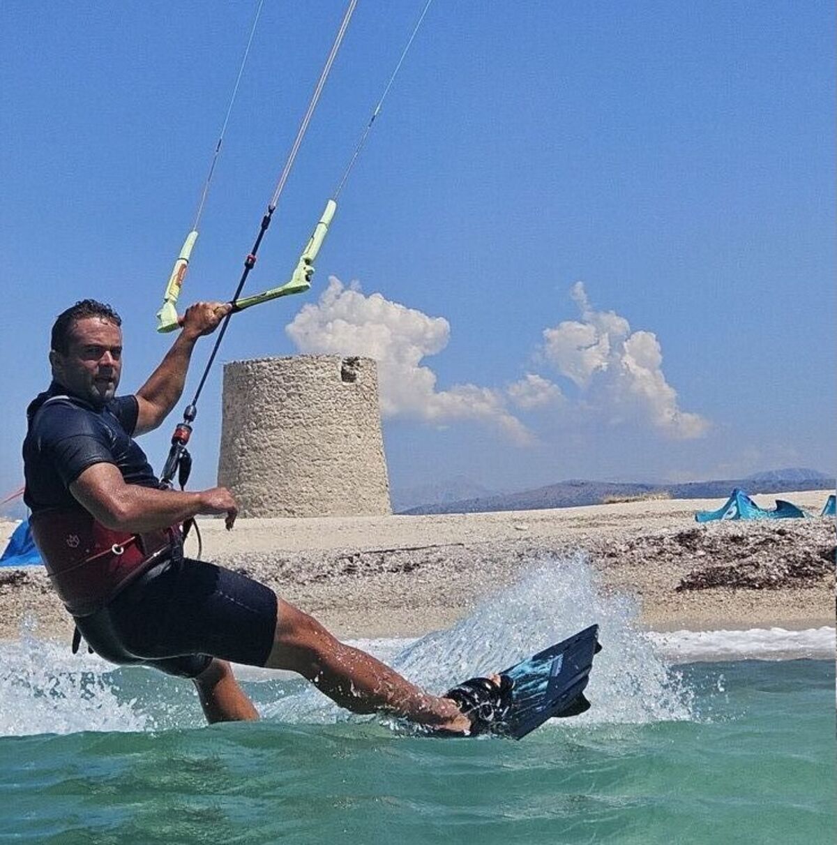 Kiteboarding action on turquoise water